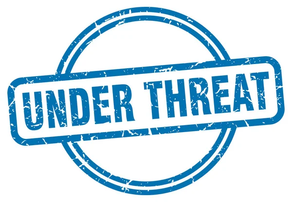 Under threat stamp. under threat round vintage grunge sign. under threat — Stock Vector