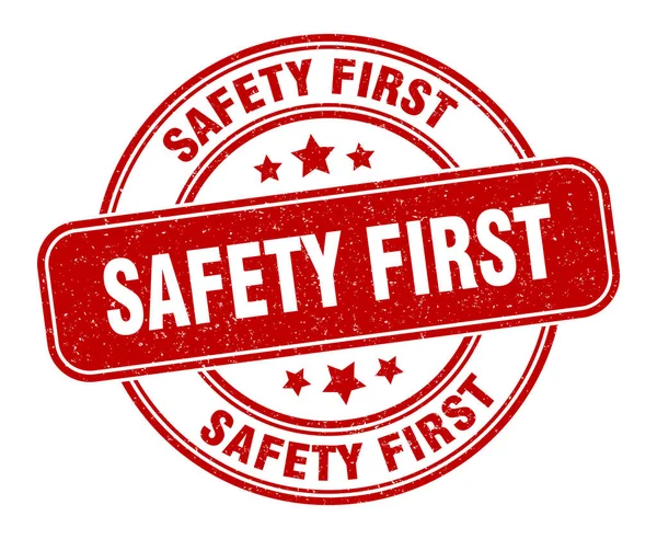 Primo Timbro Sicurezza Sicurezza Prima Etichetta Segno Grunge Rotondo — Vettoriale Stock