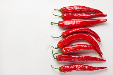 Beyaz ahşap masada kırmızı biber. Sıcak baharatlı yemek malzemesi