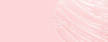 Sıvı jel dokusu, berrak serum. Pembe kozmetik cilt bakım ürünü lekesi. El dezenfektanı, alkol jeli.