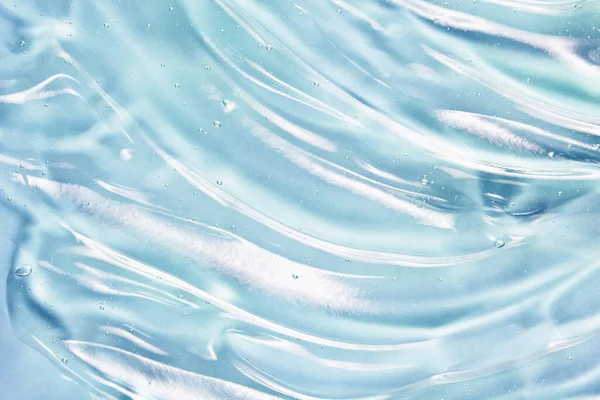 Mavi jel dokusu. El dezenfektanı, alkol jeli. Kozmetik temiz sıvı krem lekesi. Şeffaf cilt bakımı ürün örneği yakın çekim