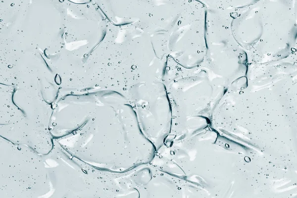 Serum dokusu, köpüklü berrak kozmetik sıvı jel. Cilt ürünleri örneği. El dezenfektanı, alkol jeli.