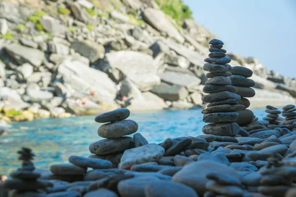 Stones towers raised close to the new beach of Vernazza, Cinque Terre, La Spezia, Italy