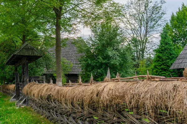 The hay and wood fence in front of Marinca House, Maramures Village Museum, Romania