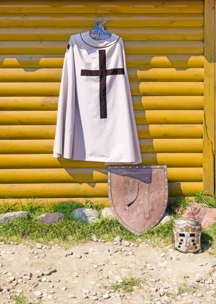 Knight cloak on wooden wall — Stock Photo, Image
