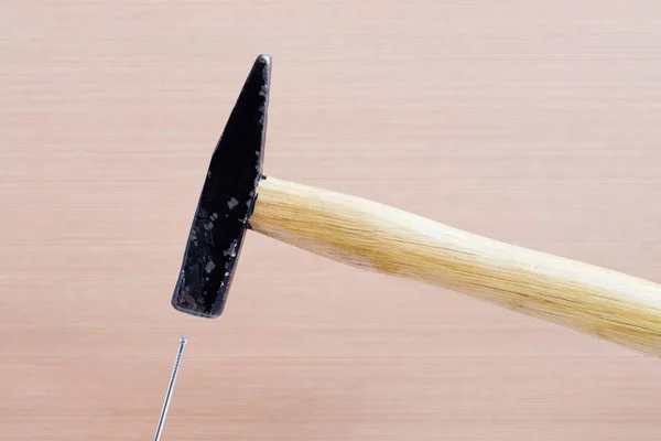 Hammer and nail on wooden background — Stock Photo, Image