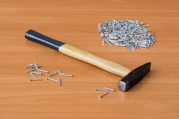 Tool and nails on wooden background — Stock Photo, Image