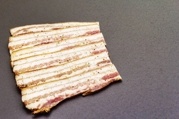 Slices of salted bacon with spices — Stock Photo, Image