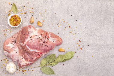 Çiğ domuz omuzu ve baharat. Saha yaprağı, sarımsak. Bir taş arkaplanda, boşluk kopyala, üst görünüm.