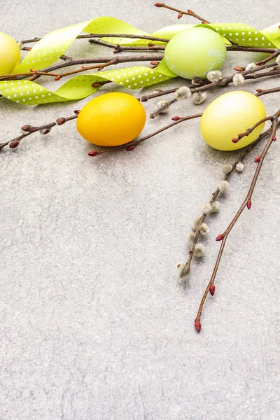Easter eggs concept willow seals branches with polka dot satin ribbons. On a stone background, copy space. — Stock Photo, Image