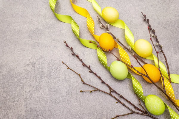 Easter eggs concept willow seals branches with polka dot satin ribbons. On a stone background, copy space, top view, wallpaper. — Stock Photo, Image