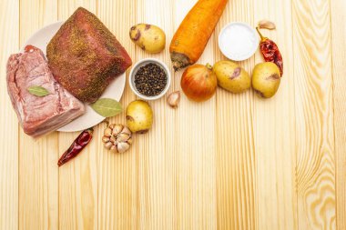 Patates ve sebzeli et güveci. Çiğ domuz filetosu, göğüs eti, arka planda baharatlar, üst manzara, kopyalama alanı.