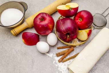 Elmalı turta malzemeleri pişirme konsepti. Tarçınlı taze elmalar, un, şeker, yumurta. Taş zemin üzerinde pişirme işlemi, kapat, makro