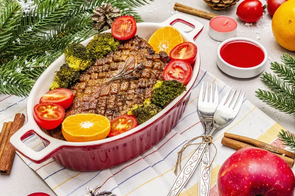 Baked duck breast on the bone with vegetables and sauce. Christmas dinner concept, New Year table setting. Stone concrete background — Stock Photo, Image