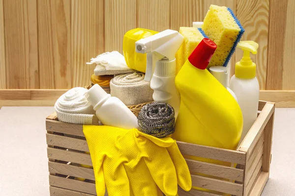House cleaning product in wooden box. Spray, bottle, gloves, dishwashing sponge, scraper, gel air freshener. Stone concrete background — Stock Photo, Image