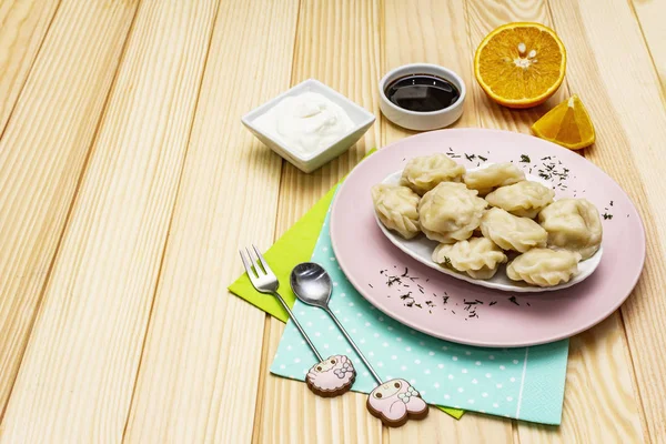 Fish dumplings. The concept of healthy food for children. Sour cream, soy sauce, cutlery. Wood background — Stock Photo, Image