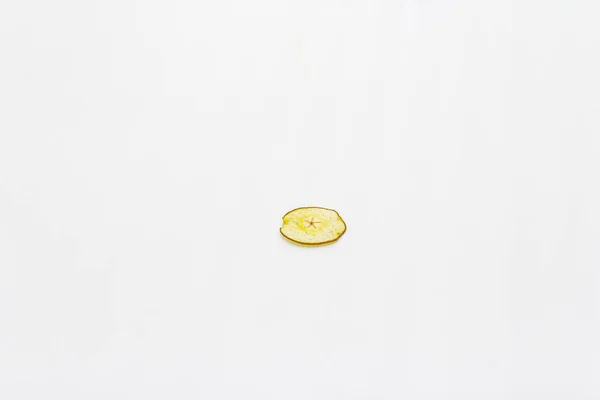 Dried single slice of pear isolated on white background