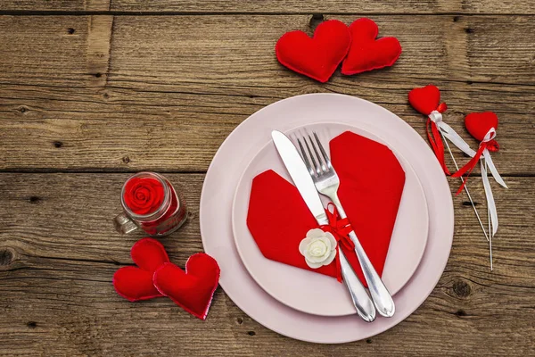 Romantic dinner table. Love concept for Valentine's or mother's day, wedding cutlery. Vintage wooden boards background