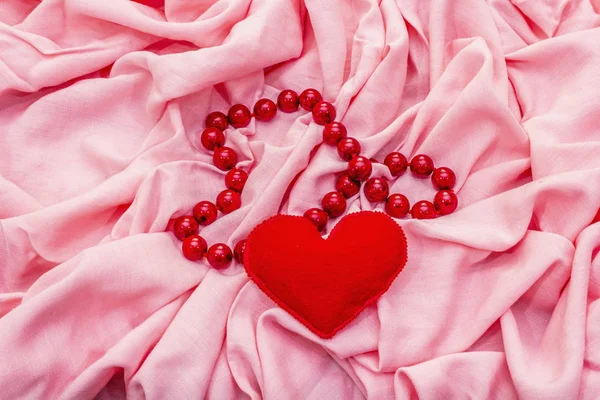 Dia dos Namorados ou conceito de cartão de casamento. Design romântico, corações de feltro vermelho, contas. Fundo de tecido rosa — Fotografia de Stock