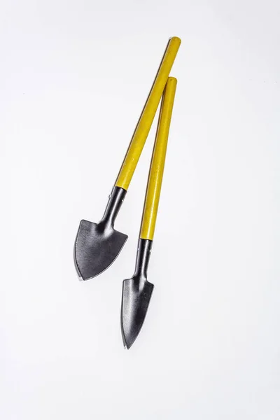 Garden tools isolated on white background. Plant care concept. Shovels and rake