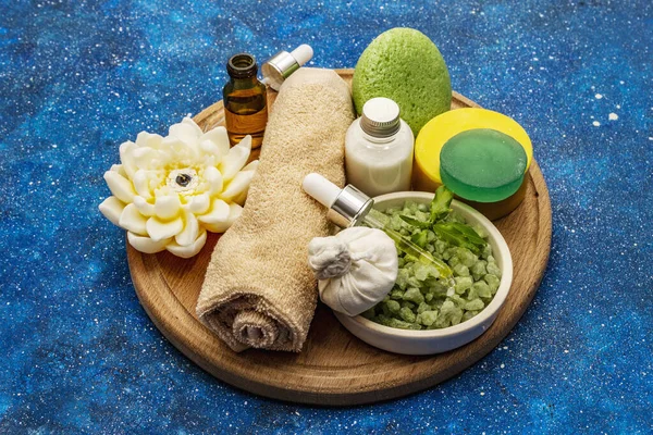 Healthy ritual of taking care of yourself. Natural cosmetics, spa set. Essential oils, sea salt, cream, sponge, towel. Nautical background, close up