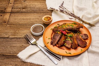 Kızarmış ördek göğsü, baharat ve yarı buzlu sos. Geleneksel Fransız yemekleri, eski ahşap tahta arka plan, kopyalama alanı