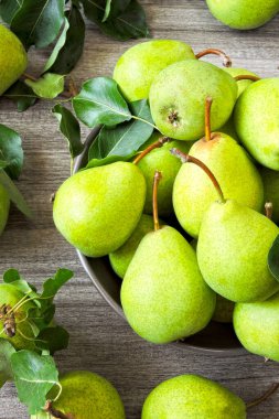 Bir kasede taze yeşil armutlar. Armut hasadı.