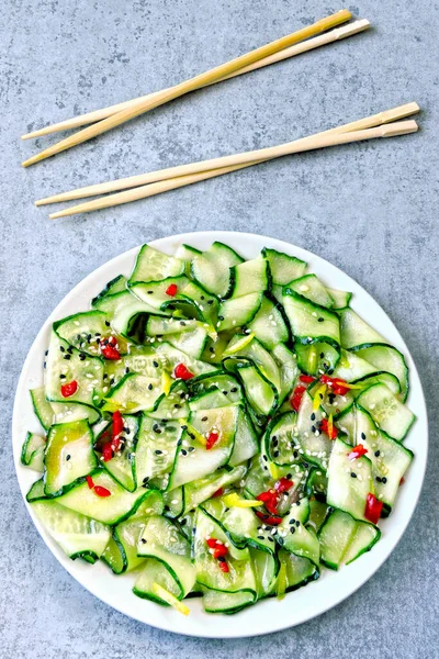 Cucumber salad in Chinese style. Salad with cucumbers and chili pepper. Chinese salad with cucumber.