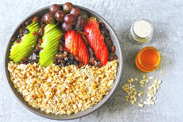 Oatmeal with fruits and seeds. Vegan breakfast bowl with oatmeal. Healthy breakfast in a bowl.