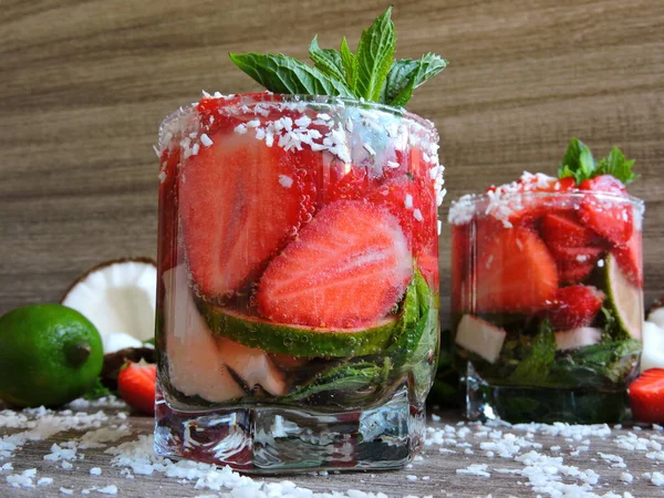Mineral water with strawberries, lime, coconut and mint. Vitamin water. Keto diet.