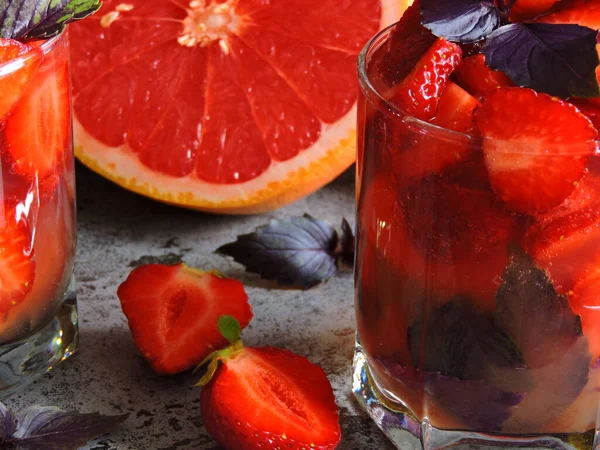 Refreshing detox drink for weight loss with strawberries, grapefruit and blue basil. Coecept of delicious and healthy food. Detox products for an ideal figure.