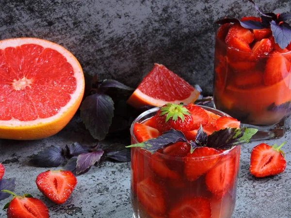 Refreshing detox drink for weight loss with strawberries, grapefruit and blue basil. Coecept of delicious and healthy food. Detox products for an ideal figure.