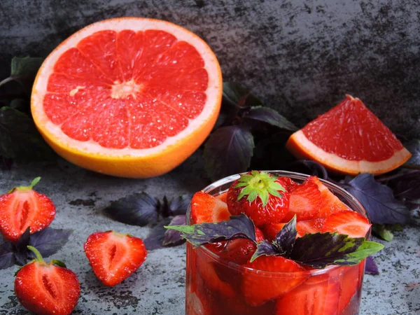 Refreshing detox drink for weight loss with strawberries, grapefruit and blue basil. Coecept of delicious and healthy food. Detox products for an ideal figure.