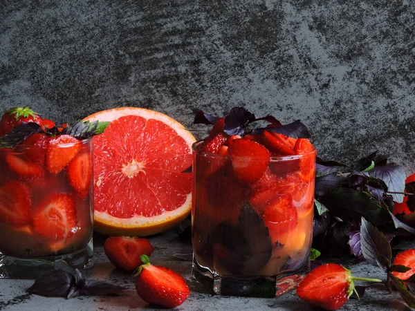 Refreshing detox drink for weight loss with strawberries, grapefruit and blue basil. Coecept of delicious and healthy food. Detox products for an ideal figure.