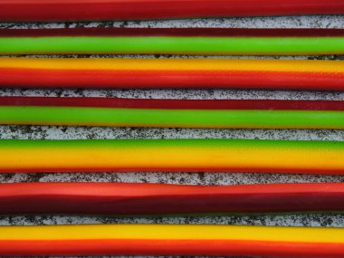 Colored fruit candy sticks. Candy-colored pencils. Copy space. clipart