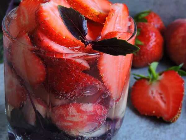 Detox drink with strawberry and peach. Strawberry peach and basil. Macro.