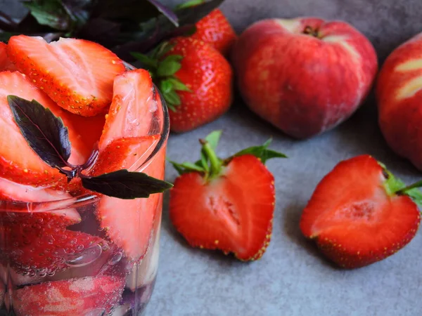 Detox drink with strawberry and peach. Strawberry peach and basil. Macro.