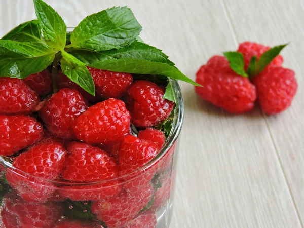 Refreshing detox drink with raspberries and mint. Raspberry mint water. Beverage for weight reduction. The concept of weight loss and a good figure.