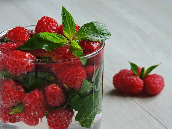 Refreshing detox drink with raspberries and mint. Raspberry mint water. Beverage for weight reduction. The concept of weight loss and a good figure.