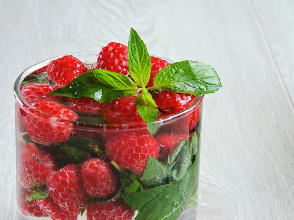 Refreshing detox drink with raspberries and mint. Raspberry mint water. Beverage for weight reduction. The concept of weight loss and a good figure.