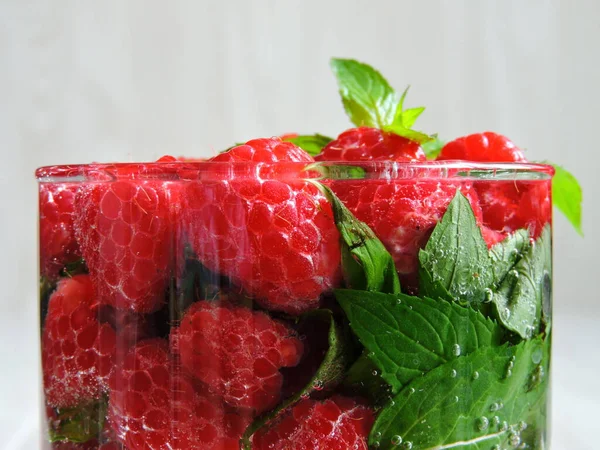 Refreshing detox drink with raspberries and mint. Raspberry mint water. Beverage for weight reduction. The concept of weight loss and a good figure.