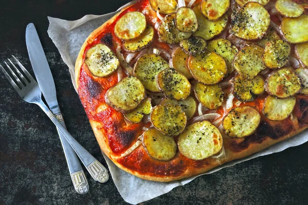 Homemade potato pizza. Vegan pizza with potatoes and onions.