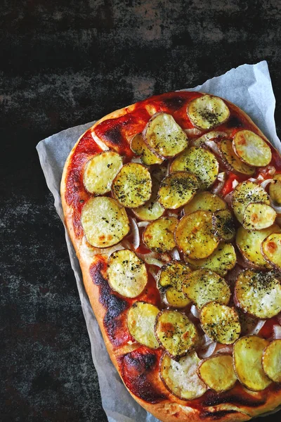 Homemade potato pizza. Vegan pizza with potatoes and onions.