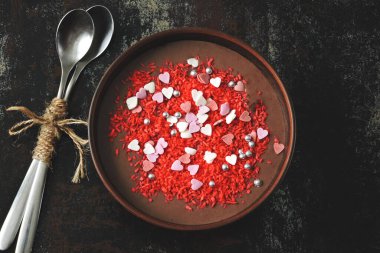 Sevgililer günü kalpleri ve dekorasyonlarıyla süslenmiş bir kasede çikolatalı puding. Aşıklar için romantik kahvaltı. Sevgililer Günü için diyet tatlı.