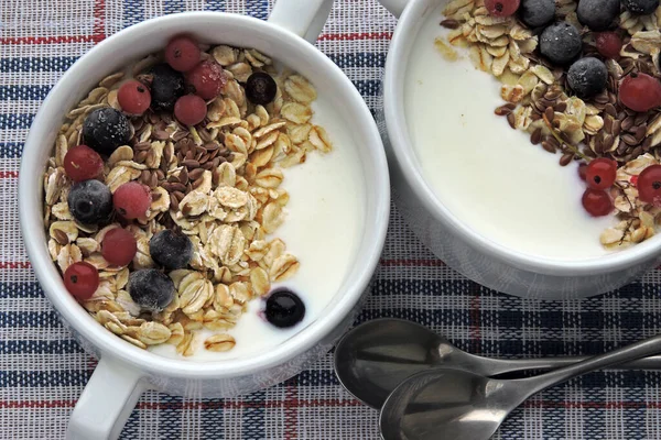 Healthy breakfast with yogurt, oatmeal, seeds and berries. Fitness breakfast or snack.
