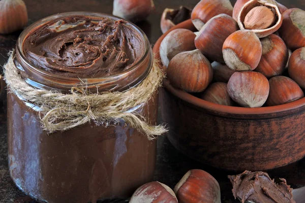 Chocolate nut paste, hazelnuts and dark chocolate. Ingredients concept of natural chocolate nut paste. Energy food. Eco food.