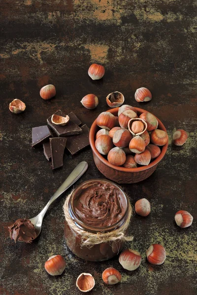 Chocolate nut paste, hazelnuts and dark chocolate. Ingredients concept of natural chocolate nut paste. Energy food. Eco food.