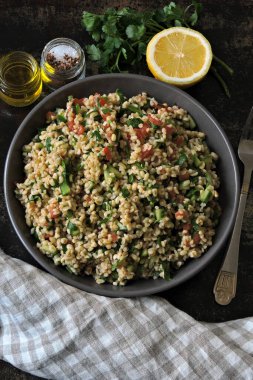 Kâse içinde Arap salatası tabağı. Orta Doğu mutfağı. Bulgur, maydanoz ve sebzeli sağlıklı salata. Bulgur 'lu vejetaryen salatası. Tabouli salatası.