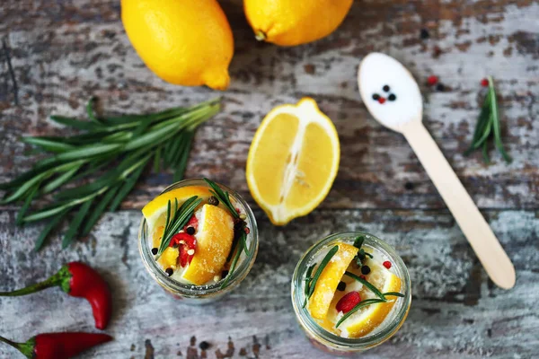 Fermented lemons in jars. Salty pickled lemon. Probiotics and fermented foods. Selective focus. Macro.