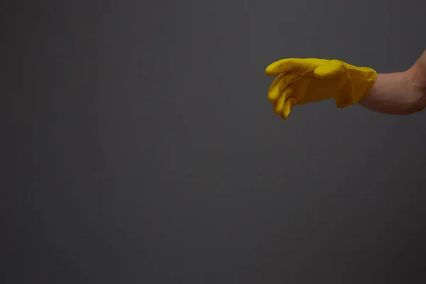 Yellow latex gloves on hand